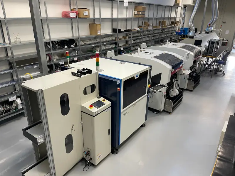 Panoramica di una linea di produzione SMT completa per l'assemblaggio di schede elettroniche, con macchinari automatizzati e stoccaggio componenti